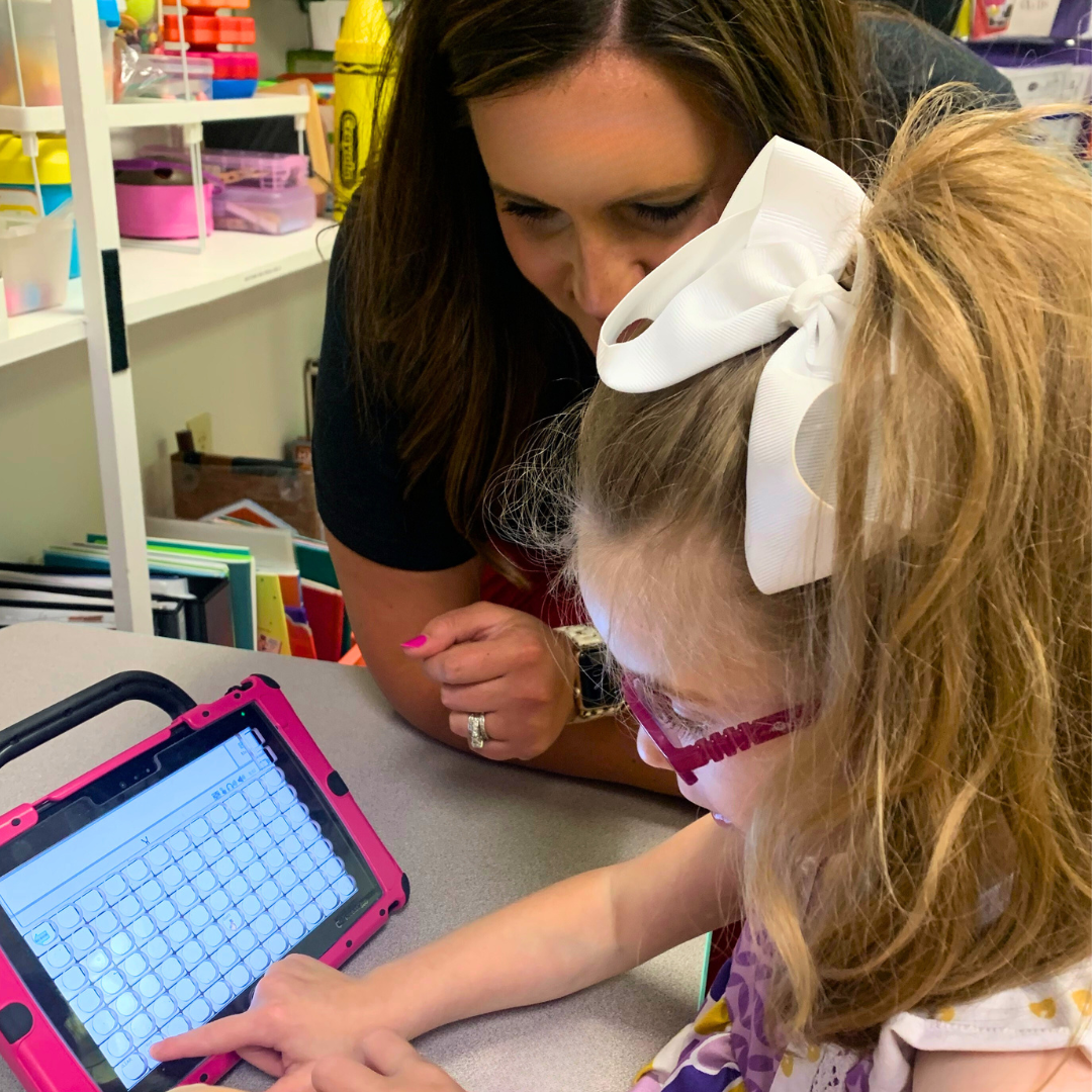 Lead speech-language pathologist working on speech therapy skills with a patient and a talk pad